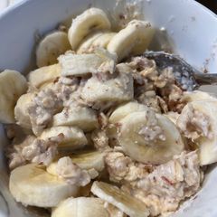 A picture of Oatmeal with Almond Milk and Banana 🍌.