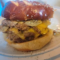 A picture of 3-4x Layers, Smothered, Covered, Smashed Onion Pretzel C/Burger.