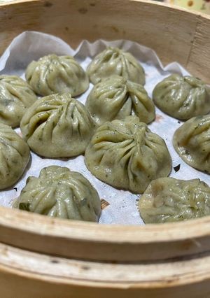 A picture of Jade Soup Dumplings (Green Xiao Long Bao).