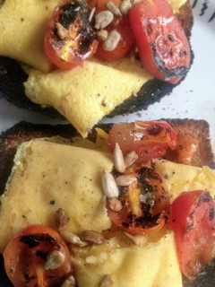Una foto de Desayuno: tostadas con huevo y tomate asado