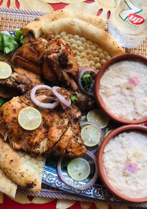 A picture of Chicken tikka with naan and firni.