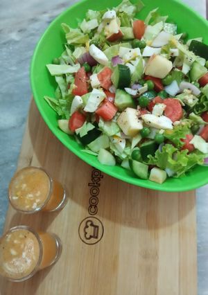 A picture of Mix Veggies salad 🥗 with orange 🍊 dressing.