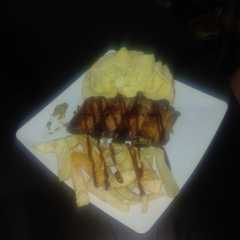 Una foto de Costillas a la BBQ en ahumador