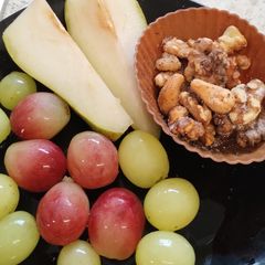 Sliced 🍐 and grapes with walnuts. Healthy Juicy snack A picture of Sliced 🍐 and grapes with walnuts. Healthy Juicy snack.
