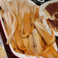 A picture of Beef Tamales with Red Chile Sauce.