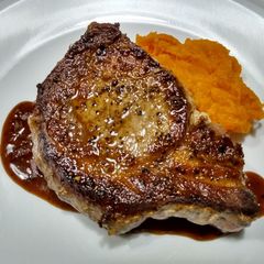 A picture of Pork chops with pan sauce.