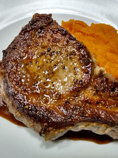 A picture of Pork chops with pan sauce.