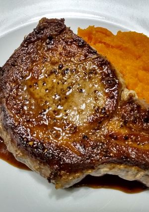 A picture of Pork chops with pan sauce.