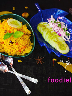 A picture of Mixed veg pulao with cucumber salad and raita.
