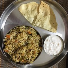 A picture of Veg Hyderabadi Biryani with Boondi raita.