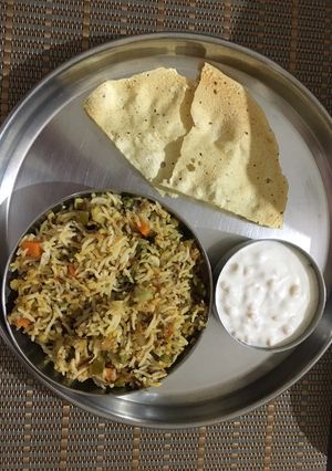 A picture of Veg Hyderabadi Biryani with Boondi raita.
