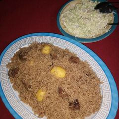 A picture of Pilau and salad.
