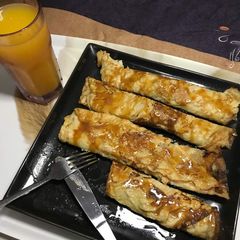 A picture of Pancake with honey and caramel syrup.