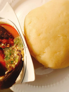 A picture of Okro and stew with garri.