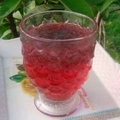 A picture of Laal sharbat with basil.