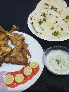 A picture of Chicken tikka with homemade tawa naan.