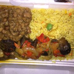 A picture of Fried rice and beans with beef kebab.