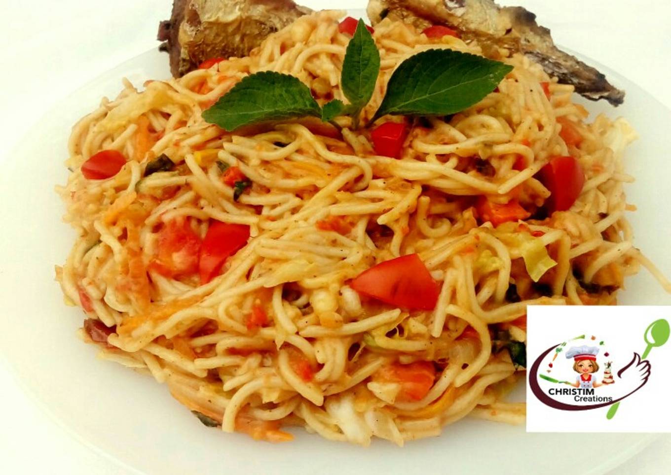 Fried fish with creamy pasta in vegetable sauce