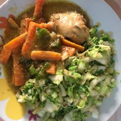A picture of Cabbage with carrots and boiled chicken.