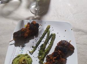 Una foto de Pinchos Morunos en salsa de guacamole y espárragos