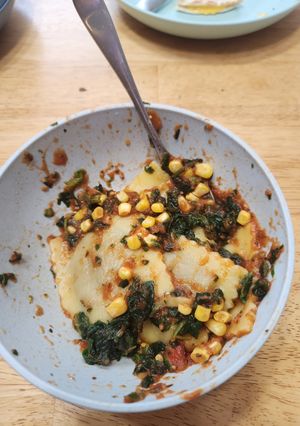 A picture of Ravioli with Corn and Spinach.