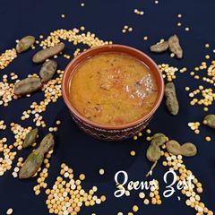 A picture of Matar Khatti Daal with Raw Tamarind.