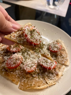 A picture of Emergency hors d’oeuvre - chapati with duck rillettes and tomato.