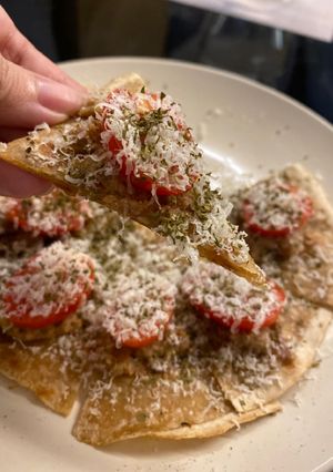 A picture of Emergency hors d’oeuvre - chapati with duck rillettes and tomato.