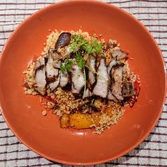 A picture of Couscous with Roasted Vegetables and Grilled Pork Belly.