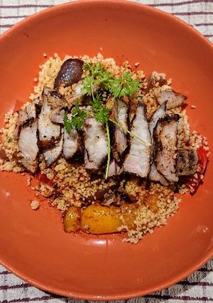 A picture of Couscous with Roasted Vegetables and Grilled Pork Belly.