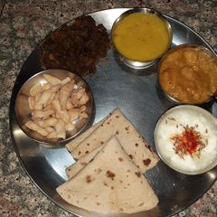 Simple thali- karari bhindi, dal, aalu sabji, dahi, roti A picture of Simple thali- karari bhindi, dal, aalu sabji, dahi, roti.