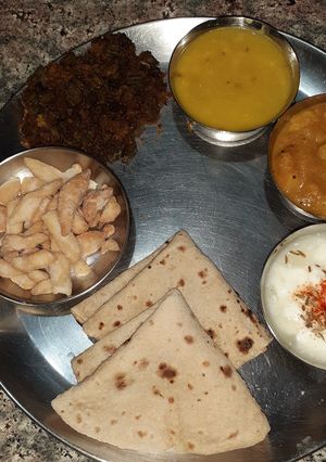 A picture of Simple thali- karari bhindi, dal, aalu sabji, dahi, roti.