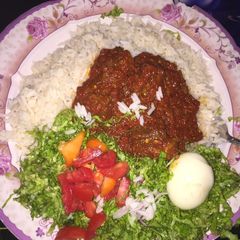 A picture of Rice and stew with salad.