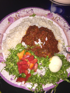 A picture of Rice and stew with salad.