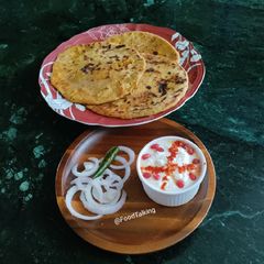 A picture of Aloo paratha with Dahi.