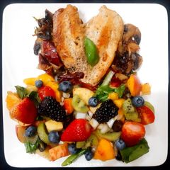 A picture of Basil Garlic Chicken with Fruit Insalata/ Salad (A Healthy Meal).
