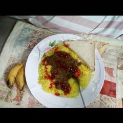 A picture of Tumeric Rice served with green grams.