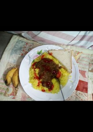 A picture of Tumeric Rice served with green grams.