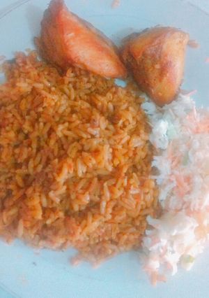 A picture of Jollof rice, coleslaw & chicken.