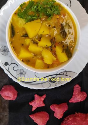A picture of Alu besan curry in frame with beetroot poori.