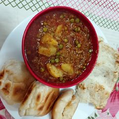 A picture of Mutton mince with potato green peas.