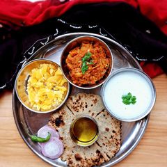 A picture of Baigan no bharta/ringan no olo and bajri no rotla.