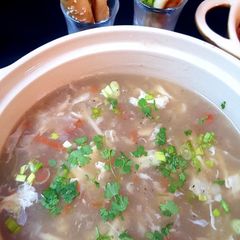 A picture of Shangrila soup with bread sticks.