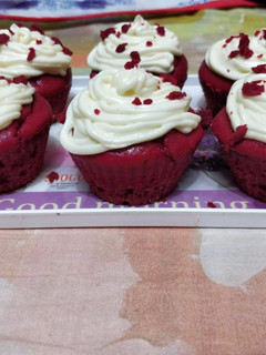 A picture of Red velvet cupcake with a cream cheese frosting.