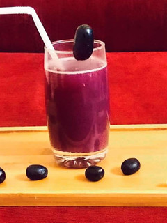 A picture of Black grapes and pomegranate juice.