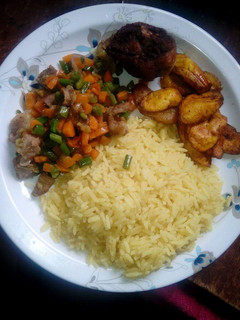 A picture of Curry Rice with little veggies on the side.