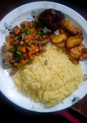 A picture of Curry Rice with little veggies on the side.