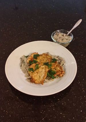 A picture of Chicken Schnitzel with a Creamy Mushroom Sauce.