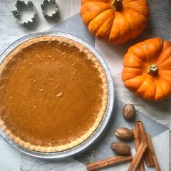 A picture of Pumpkin Pie with Cream & Maple syrup.