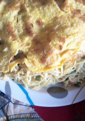 A picture of Indomie Noodles and fried eggs.
